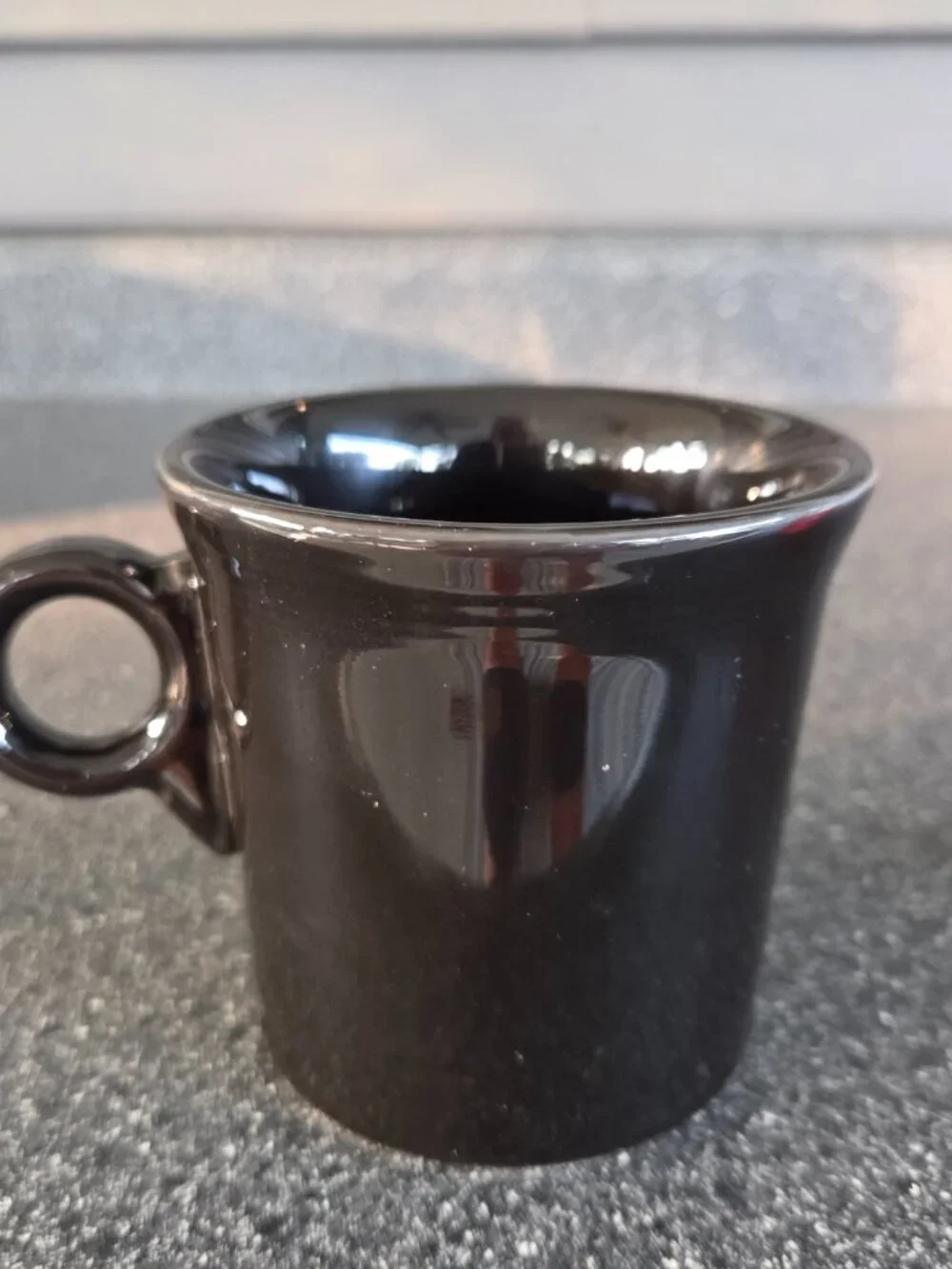 Fiestaware ceramic mugs in black and red with a ring handle, 10.25 oz capacity.